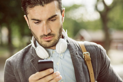 Businessman using smart phone outdoors