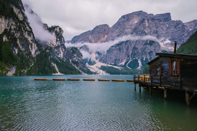 Scenic view of lake by snowcapped mountains against sky