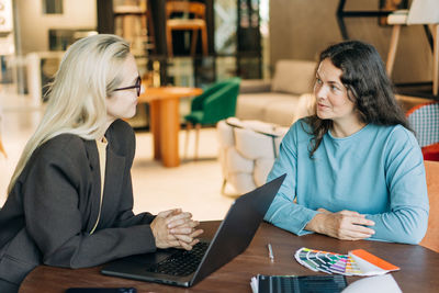 Businesswoman using laptop at table