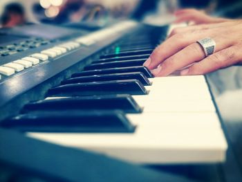 Cropped hands playing piano