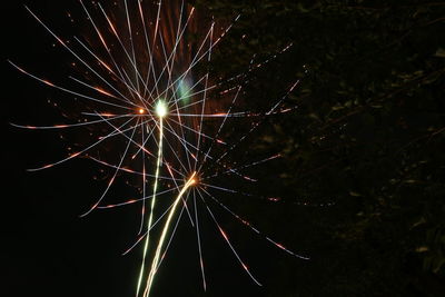 Low angle view of firework display at night