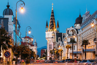 Illuminated city against clear sky