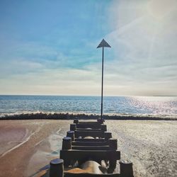 Lifeguard hut on beach against sky