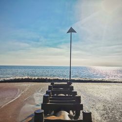 Lifeguard hut on beach against sky