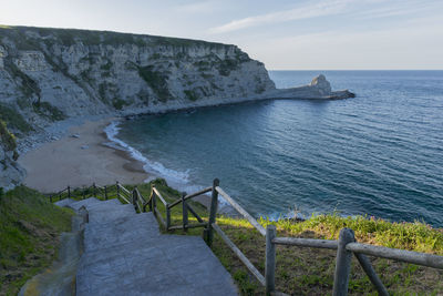 High angle view of steps by sea against sky