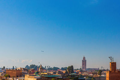 Buildings in city against blue sky