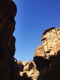 Low angle view of rock formations against blue sky