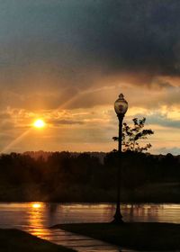 Street light against orange sky