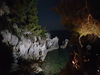 Scenic view of cave and sea at night