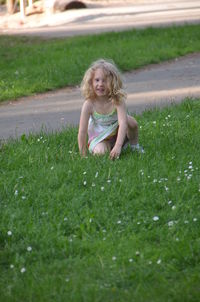 Portrait of cute girl playing on grassy field