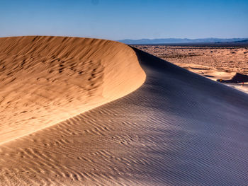 Scenic view of desert against clear sky