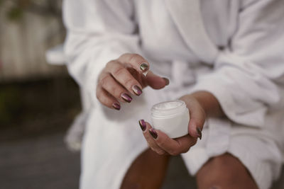 Woman's hands holding moisturizer