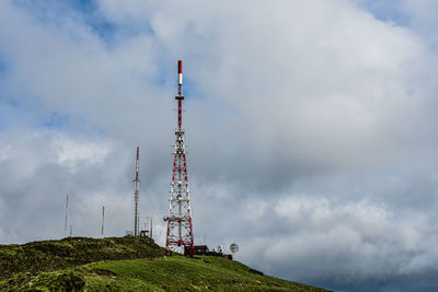 Low angle view of communications tower against sky