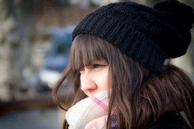 Close-up of woman in knit hat looking away