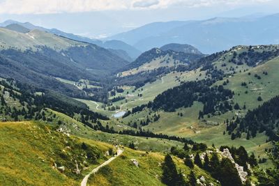 Scenic view of valley and mountains against sky