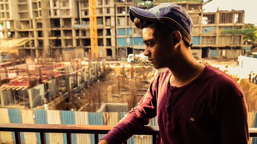 Portrait of young man looking at city