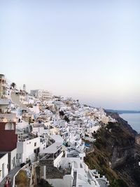 High angle view of town by sea against clear sky