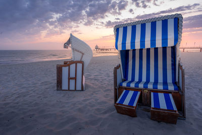 Two beach chairs at the beach at sunrise