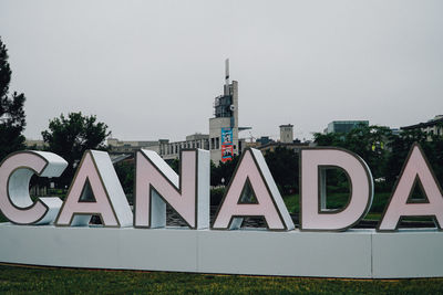 Information sign on building against sky