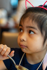 Close-up portrait of a girl looking away