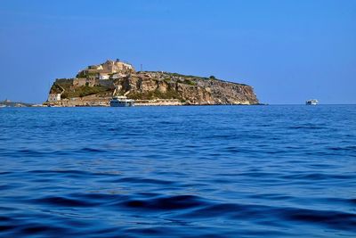 Scenic view of sea against clear blue sky