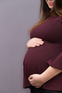 Midsection of woman with arms raised