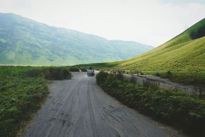 Off-road vehicle driving on dirt road