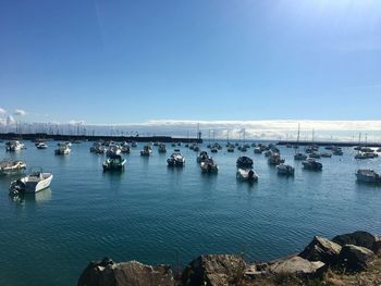 Sailboats in sea against sky