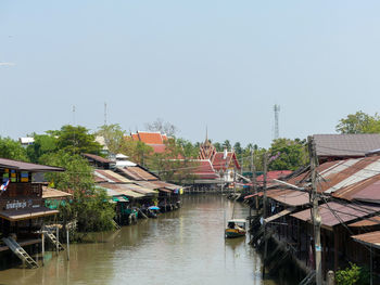 Canal amidst buildings against sky