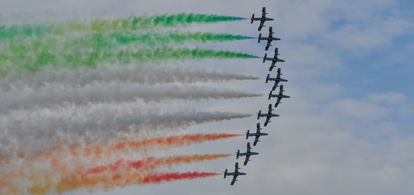 Low angle view of airshow against sky