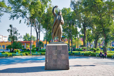 Statue against trees and plants