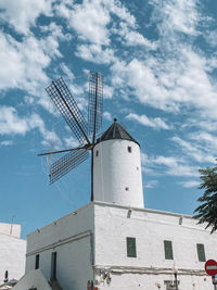 Low angle view of traditional windmill against sky