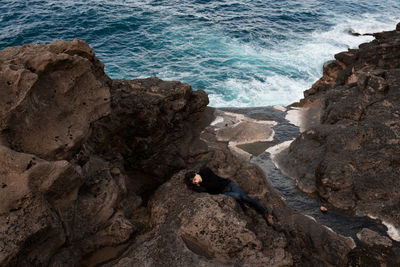 Man lying down on seashore