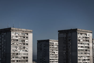 Exterior of buildings in city against clear sky