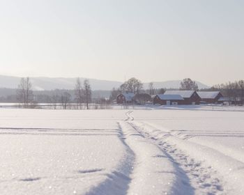 Snow covered field against sky