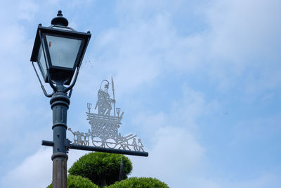 Low angle view of street light against building