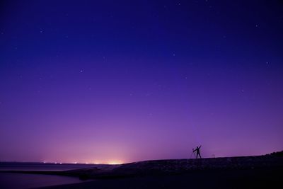 Scenic view of landscape against clear sky at night