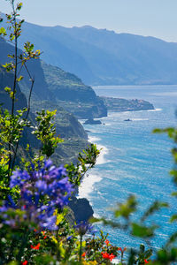 Scenic view of sea and mountains against sky