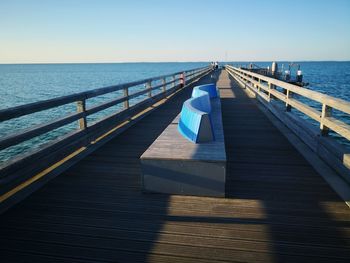 Pier over sea against clear sky