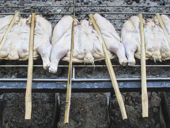 High angle view of chicken meat on barbecue grill