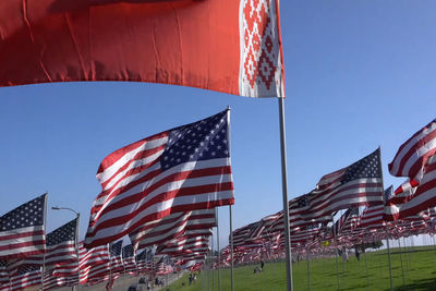 Low angle view of flags against the sky
