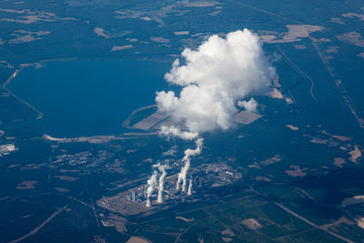 Aerial view of smoke emitting from cooling towers 