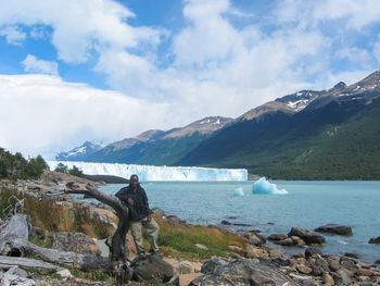 Scenic view of sea and mountains against sky