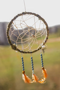 Close-up of dreamcatcher hanging outdoors