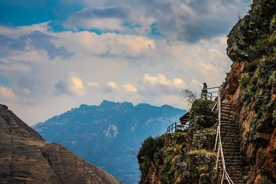 Low angle view of woman at observation point against sky