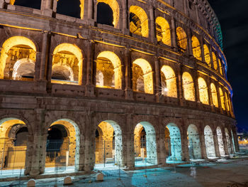 Low angle view of coliseum against sky