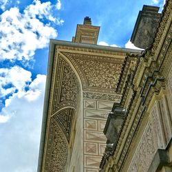 Low angle view of historical building against cloudy sky