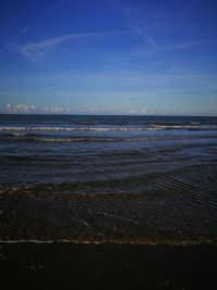 Scenic view of sea against blue sky