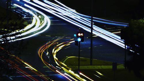 Light trails on bridge in city at night