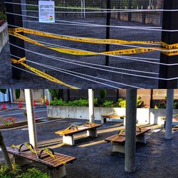 High angle view of yellow road sign on street in city